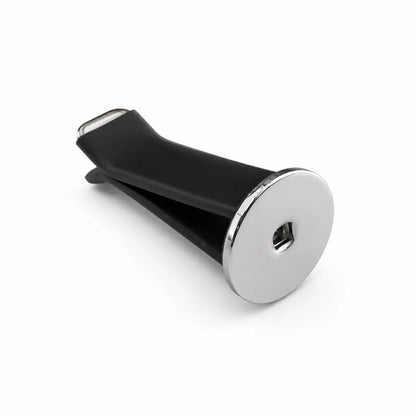 Side view of a black-and-white dog head car vent clip accessory mounted on a metallic ring and V-shaped clamp, isolated on a clean white studio background with minimal shadows, product-style presentation.